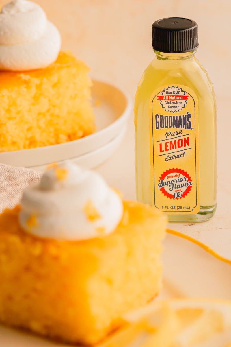 Goodman's Pure Lemon Extract bottle with a cake in the background