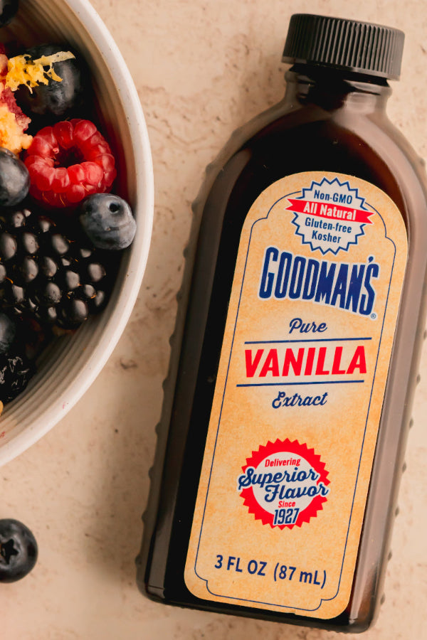 Goodman's Pure Vanilla Extract bottle with berries on a beige background